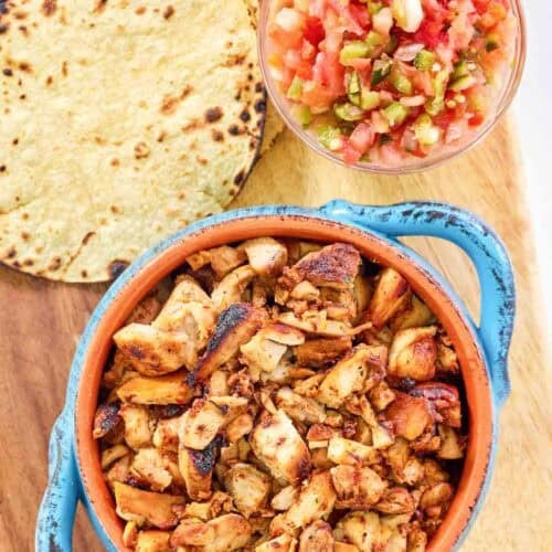 Lime, pineapple, chipotle, adobo, and anchiote pepper chicken served with tortillas.