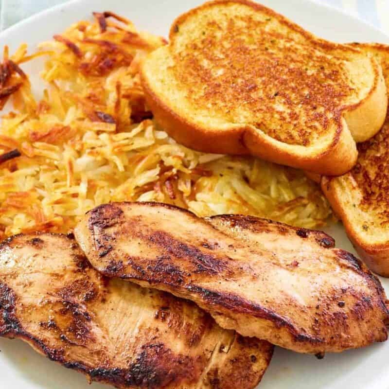 Marinated and grilled chicken served with hashbrowns and toast.