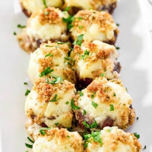 Baked mushrooms with cheesy stuffing, crunchy breadcrumb topping, and Alfredo sauce.