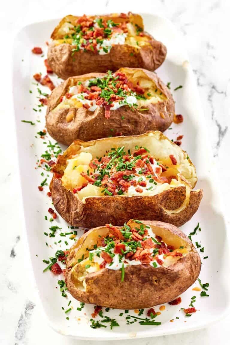 Baked russet potatoes loaded with toppings.