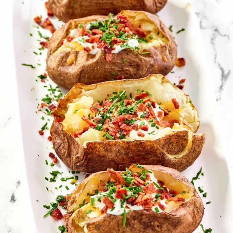 Baked russet potatoes loaded with toppings.