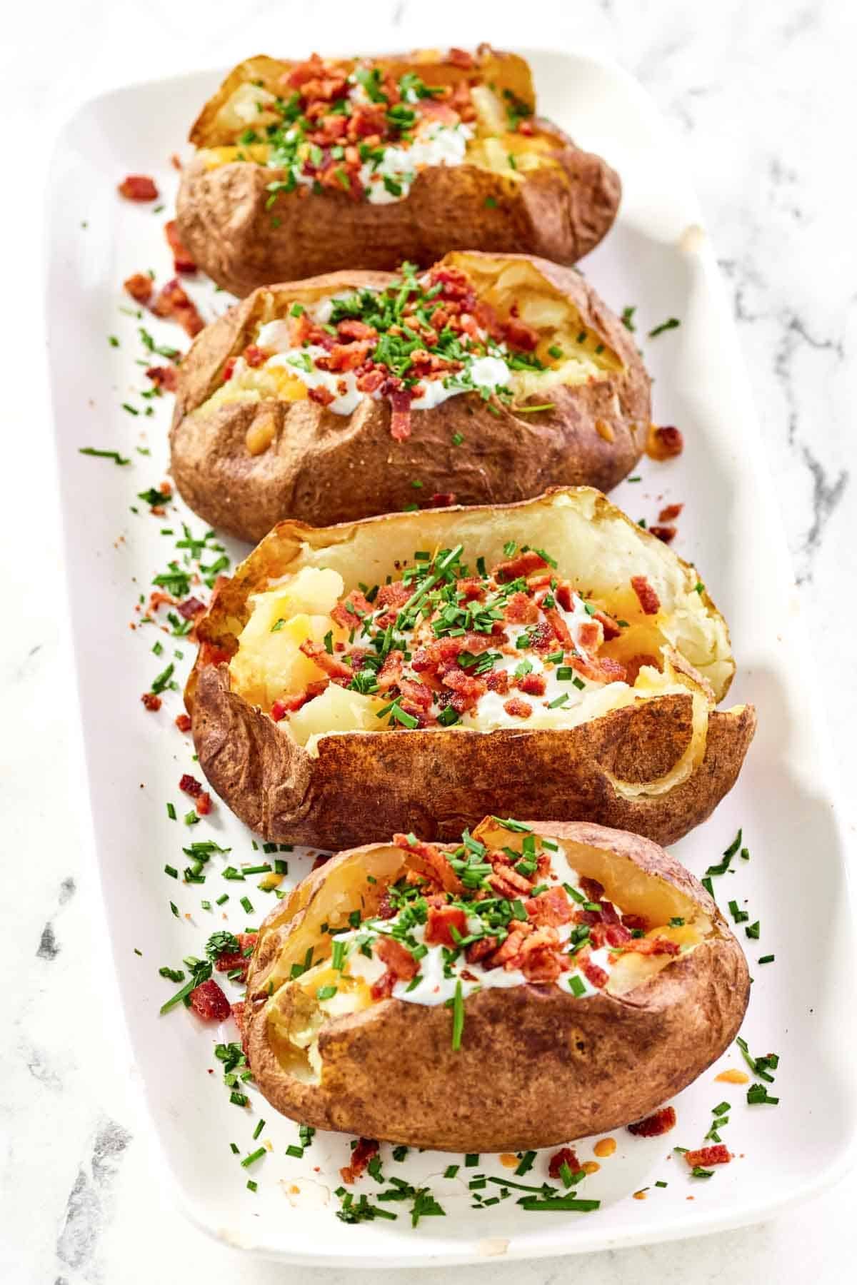 Baked russet potatoes loaded with toppings.