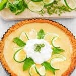 Copycat Anthony's key lime pie garnished with lime slices, mint leaves, and whipped cream.