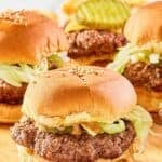 Homemade Big Mac sliders with lettuce, pickles, onions, cheese, and special sauce.