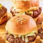 Big Mac sliders with special sauce, American cheese, lettuce, pickles, and onions on sesame seed buns.