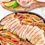 Copycat Chili's chicken fajitas with onions and peppers.