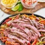 Copycat Chili's steak fajitas, shredded cheese, and pico de gallo.