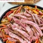 Copycat Chili's steak fajitas on a cast-iron plate.