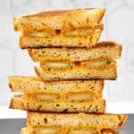 Halves of copycat Denny's fried cheese melt sandwiches in a stack.