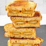 Copycat Denny's fried cheese melt sandwich halves in a stack.