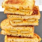 Copycat Denny's fried cheese melt sandwiches sliced in half and stacked.