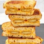 Copycat Denny's fried cheese melt sandwiches cut in half and stacked.