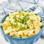 Copycat Kenny & Ziggy's egg salad in a small bowl on a marble surface.