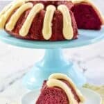 Copycat Nothing Bundt Cakes red velvet bundt cake slice on a plate and the cake behind it.