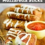 A platter of copycat Olive Garden fried mozzarella sticks served with marinara sauce.