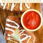 Copycat Olive Garden fried mozzarella sticks served with marinara on a wooden platter.
