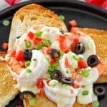 Copycat Olive Garden Sicilian Scampi garnished with olives, tomatoes, and green onions.