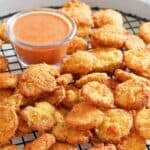 Copycat Red Robin fried pickles (pickle nickels) served with dipping sauce.