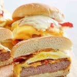 Copycat Wendy's breakfast baconator sandwiches on a wood cutting board.