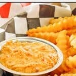 Copycat Whataburger creamy pepper sauce and French fries in a serving basket.