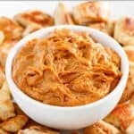 A bowl of homemade Japanese hibachi style yum yum sauce surrounded by grilled chicken pieces.