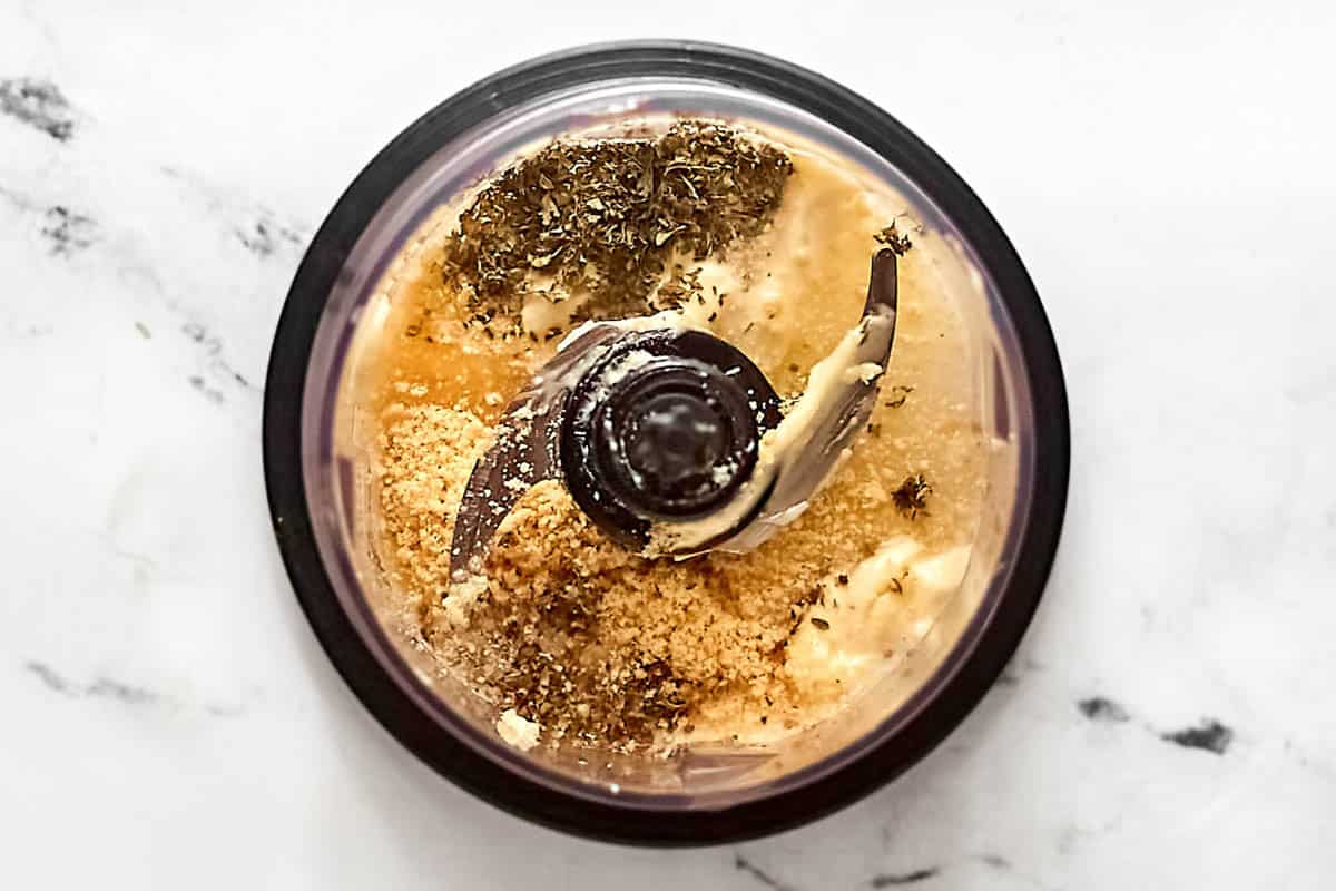 Mayonnaise, vinegar, oil, cheeses, lemon juice, garlic, and seasonings in a blender.