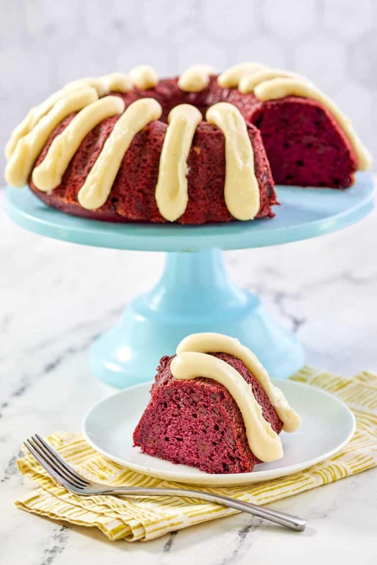 A bundt cake that's red velvet chocolate chip with piped cream cheese frosting.