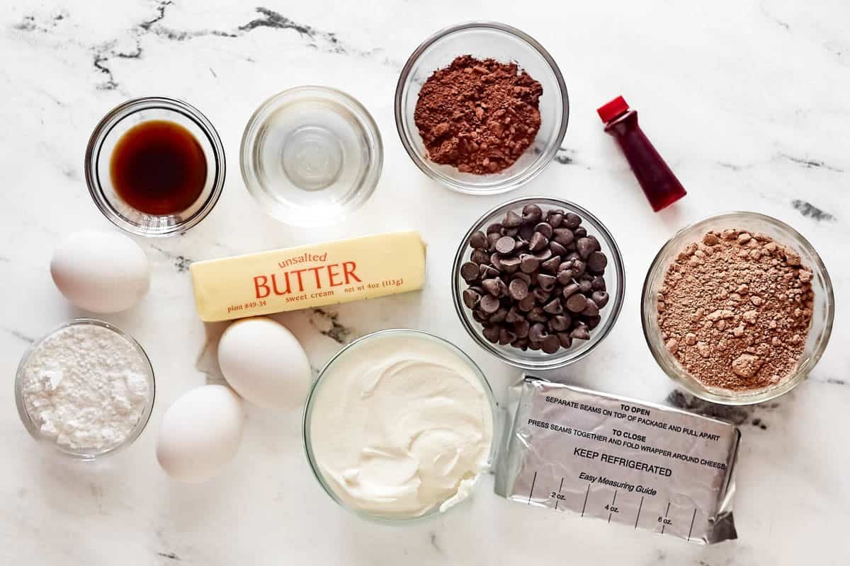Chocolate cake mix, cocoa powder, chocolate chips, eggs, sour cream cream cheese, powdered sugar, vanilla, and red food coloring.