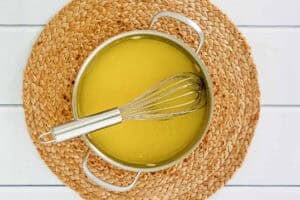 Cooking a creamy lemon filling for a pie.