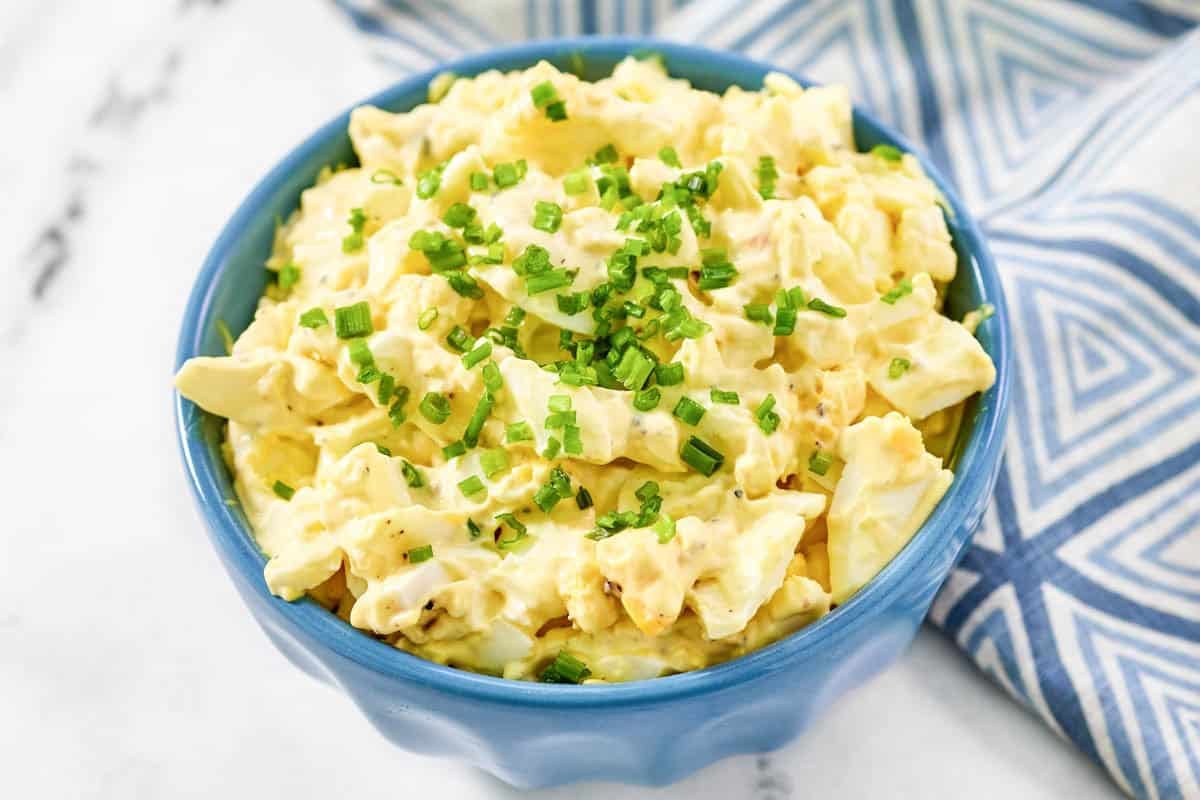 Creamy egg salad garnished with chives.