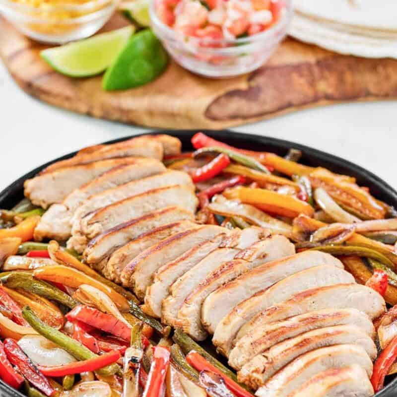 Fajitas with chicken and veggies served with tortillas, cheese, sour cream, and pico de gallo.