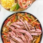 Fajitas with steak and veggies served with tortillas, cheese, pico de gallo, and sour cream.