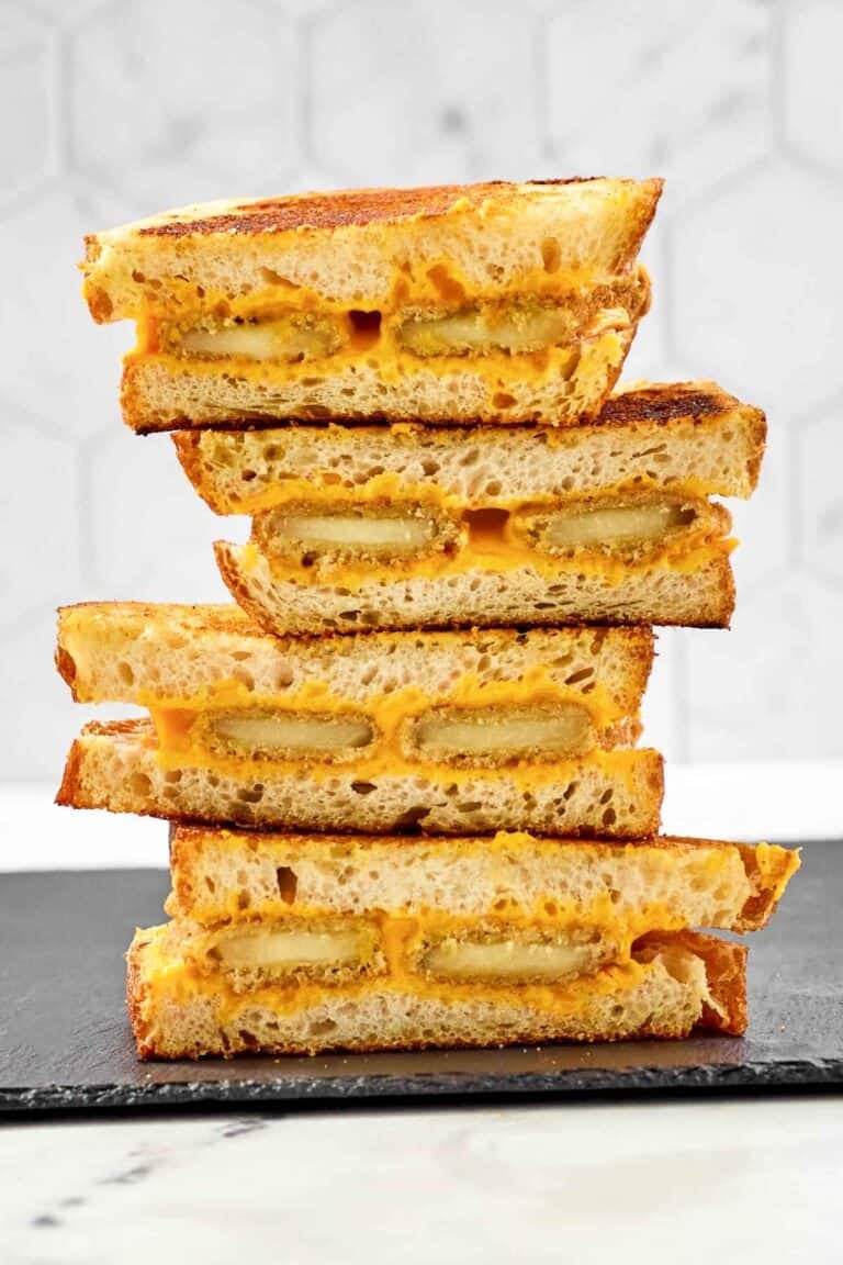 Slices of fried cheese grilled cheese sandwiches in a stack.