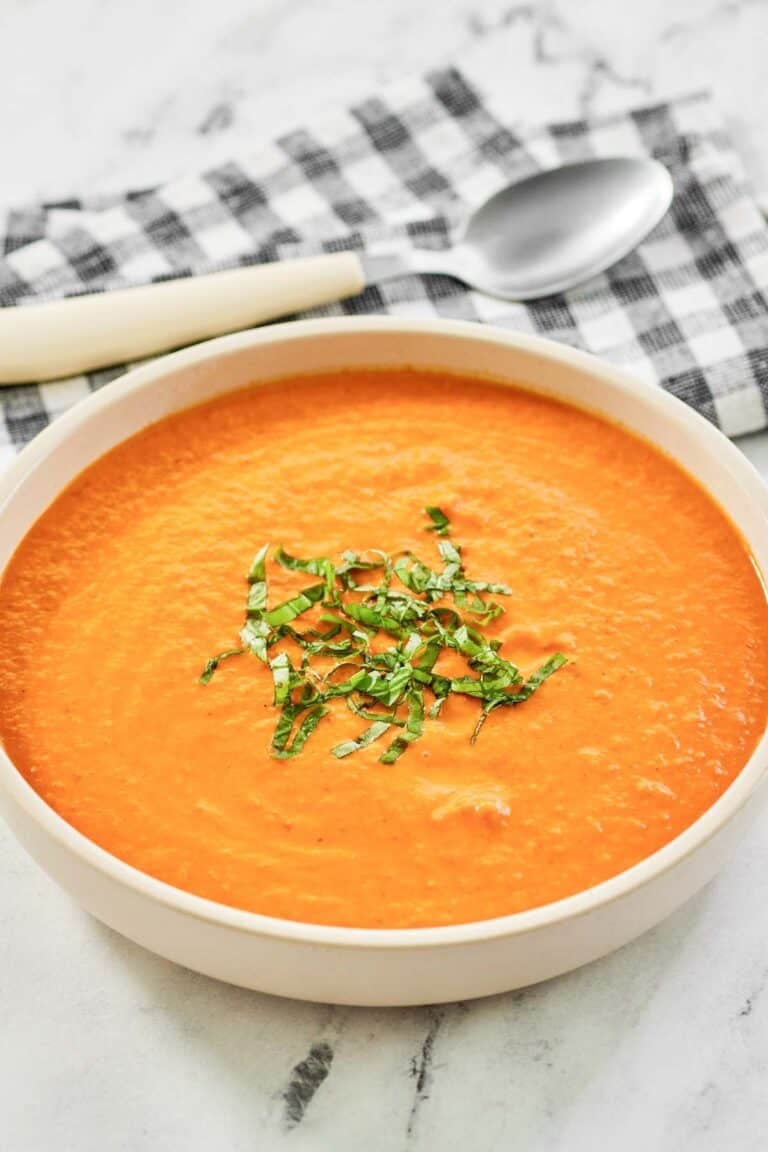 Tomato soup garnished with thinly sliced basil.