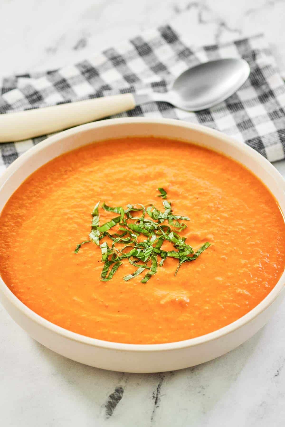 Tomato soup garnished with thinly sliced basil.