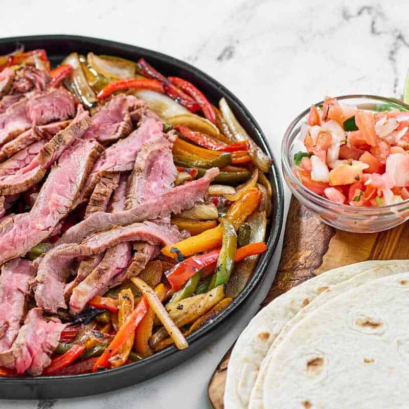 Grilled steak, bell peppers, and onions served with tortillas, pico de gallo, cheese, and sour cream.