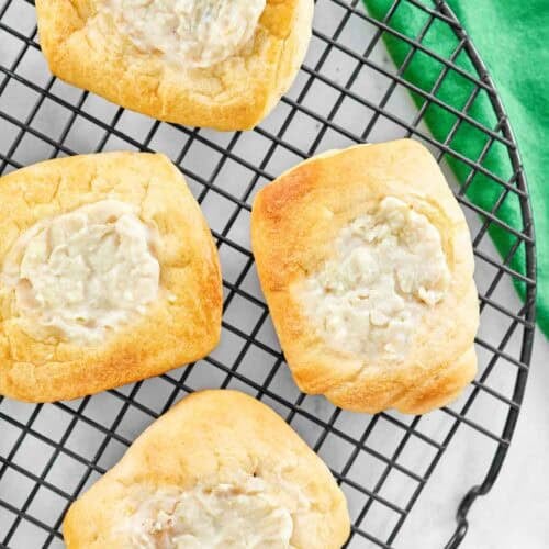 Homemade lemon cheese danishes cooling on a wire rack.