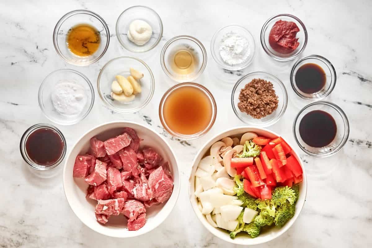 Sirloin steak, chopped vegetables, garlic, sauces, and seasonings.