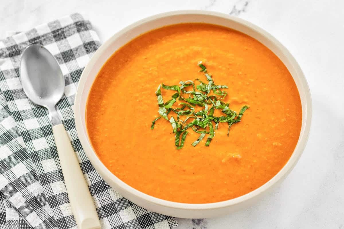A bowl of soup made with tomatoes and cream.