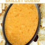 Copycat Chili's skillet queso made in a slow cooker and served in an iron dish with tortilla chips.