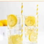Two glasses of homemade lemonade with ice and lemon slices.