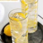 Lemon slices and homemade lemonade in two glasses.