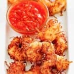 Copycat Joe's Crab Shack coconut shrimp with dipping sauce on a platter.