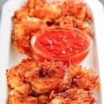 Copycat Joe's Crab Shack coconut shrimp and dipping sauce on a platter.