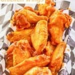 Louisiana hot sauce chicken wings in a parchment paper-lined serving basket.