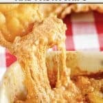 A fried lasagna noodle dipping into copycat Olive Garden lasagna dip.