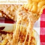 A fried pasta chip dipping into copycat Olive Garden lasagna dip.