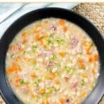 Copycat US senate navy bean soup in a large bowl on a braided placemat.