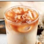 Copycat Starbucks iced apple crisp macchiato and cinnamon sticks beside it.