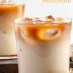 Two glasses of copycat Starbucks iced apple crisp macchiato and two cinnamon sticks.